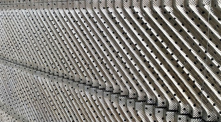 High-speed photography of liquid curtain forming through perforation versus dry spots on unperforated plate